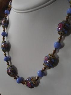 "Gorgeous, authentic Murano, vintage Venetian \"wedding cake\" glass bead handmade necklace with blue, pink, and aventurine flecked gold glass from Murano, Italy, 1970s. Beautiful blue beads of different shapes, with pink rose flowers and gold aventurine flecks threaded through the design of the large beads, alternating with smaller solid blue glass beads and gold-fill and brass spacer beads. Vintage Italian glass artistry from the 70s. A wonderful \"something blue\" for a bride, a perfect weddi Single Strand Czech Glass Necklace With Round Beads, Single Strand Czech Glass Necklaces With Round Beads, Costume Jewelry Necklaces With Czech Glass Polished Beads, Costume Jewelry Necklaces With Polished Czech Glass Beads, Vintage Murano Glass Necklace With Large Beads, Vintage Murano Glass Beaded Necklace With Large Beads, Blue Murano Glass Necklace With Polished Beads, Blue Single Strand Murano Glass Beaded Necklace, Vintage Blue Glass Jewelry