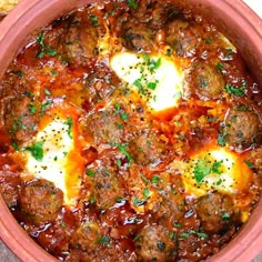 meatballs in tomato sauce with cheese and parsley on top, ready to be eaten