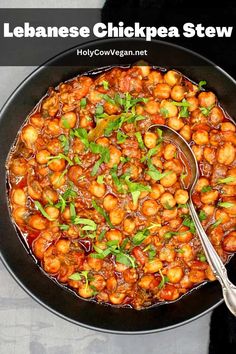 a pan filled with chickpea stew on top of a table