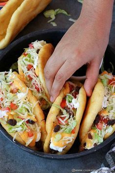 taco bell copycat chaupa in a cast iron skillet with hands reaching for it