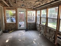 an empty room with several windows and insulation on the ceiling is being worked on in preparation for remodeling