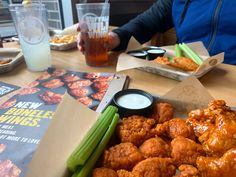 a person sitting at a table with some food