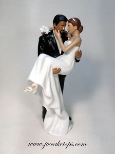 a bride and groom figurine holding each other