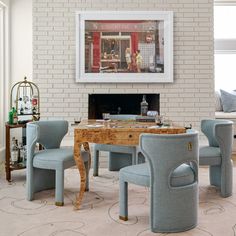 a living room filled with furniture and a fire place next to a brick wall in front of a fireplace