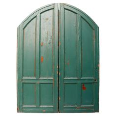 an old green double door with rusted paint on the sides and bottom panels, isolated against a white background