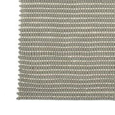 a close up view of an area rug that is made out of grey fabric with white dots