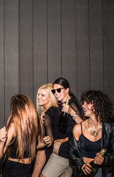 group of young women dancing and having fun at a club or party by the wall