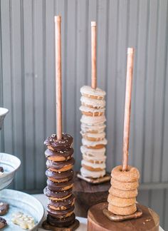 several donuts are stacked on top of each other with candles sticking out of them