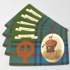 four placemats with scottish tartan designs and an image of a man in kilt