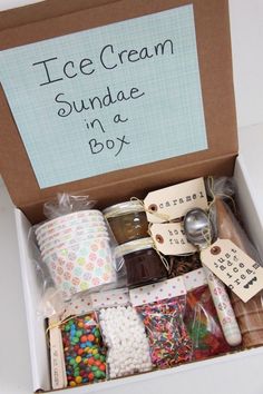 an ice cream sundae in a box is packed with candy, candies and other items