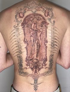 the back of a man with a tattoo on his upper body and an angel above it