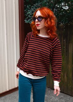 '90s vibes ahead with this classic, lightweight crew neck sweatshirt made of Daydreamer's newest lightweight french terry with vintage feeling and lived-in look. Mahogany (reddish brown) and black stripe with cream trim at collar, cuffs, and hem. Features: Slouchy fit sweatshirt Lightweight 100% French Terry Crew neckline Raglan long sleeves Long sleeves with ribbed cuffs Mahogany brown and black stripe Cream trim along collar, cuffs, and hem Ethically made in California Brand & Fabric Content: Brand: Daydreamer Materials: 100% french terry cotton | Machine Wash Cold Made in: California Fit: True to size. For an extra oversized fit, size up a size. Taylor (redhead) is 5'3 with a 30C bust, 24" waist and wears size XS. Daydreamer's model wears size small. Approx. measurements, taken laying f Stripe Sweatshirt, Cream Trim, Vintage Feeling, Mahogany Brown, Ankle Length Skirt, Ragged Priest, 90s Vibes, Striped Sweatshirts, Skirt Jumpsuit