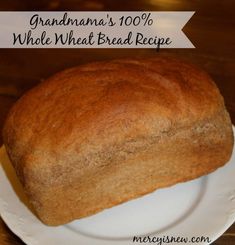 a loaf of bread on a plate with the words grandma's 100 % whole wheat bread