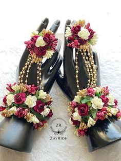 two black shoes with flowers and pearls on them