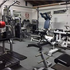 an empty gym room with various machines and equipment