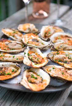 a plate full of oysters on a wooden table