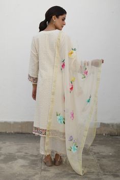 Ivory A-line asymmetric hem kurta with floral embroidery detailing. Comes with pant and dupatta.
Component: 3
Pattern: Embroidery
Type Of Work: Floral
Neckline: Round
Sleeve Type: Long
Fabric: Kurta: Seersucker Checks, Pant: Cotton, Dupatta: Chanderi
Color: Ivory
Other Details: 
Approx Kurta Length: Shortest 43 inches, Longest 48 inches
Approx Pant Length: 38 inches
Note: The inner worn by the model is not for sale
Occasion: Mehendi and Haldi,Puja - Aza Fashions Lehenga Kurta, A Line Kurta, Embroidery Detailing, Cotton Dupatta, Embroidery Floral, Pattern Embroidery, Pant Length, Kurta Set, Color Ivory