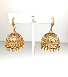 Classy jhumka in fish hook style, antique gold plating with intricate design, studded in micro CZs and gold ball hangings. Statement jhumka. Ornate and beautiful butta design. Lightweight jhumki. Butta Design, Antique Gold Earrings, Gold Jhumka Earrings, Gold Earrings Models, Gold Earrings Designs, Jhumka Earrings, Hanging Earrings, Intricate Design, Ear Jewelry