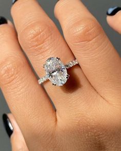 a woman's hand with a ring on it and a diamond in the middle