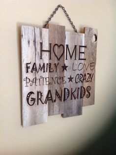 two wooden signs hanging on a wall with chains attached to them that read home, family love, prince crazy grandkids