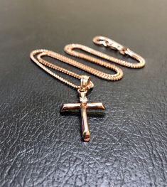 DeKara Designs Clearance Metal- 14K Rose Gold, .583. Stone- 1 Round Diamond F-G Color VS1-VS2 Clarity, 0.07 Carats. Modern Minimalist Handmade 14K Rose Gold Diamond Cross Necklace/Pendant. The center of the cross has a professionally prong set round fiery diamond. The cross is 1.20 inches long including the bail and 0.62 inches wide. The cross has a beautiful shine with a high polished finish. Necklace is a beautiful diamond cut wheat chain made in 14K Rose Gold and is 16 inches in length. FREE Rose Gold Pendant Necklace With Box Chain, Fine Jewelry Rose Gold Box Chain, 14k Rose Gold Pendant Jewelry, 14k Rose Gold Necklaces For Gifts, 14k Rose Gold Necklace For Gift, Gift Rose Gold Necklace In 14k Rose Gold, Gift Rose Gold Necklace In 14k, Rose Gold Cross Pendant Necklace In Fine Jewelry Style, Fine Jewelry Rose Gold Cross Pendant