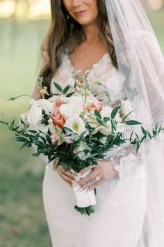 a woman in a wedding dress holding a bouquet