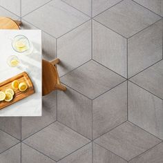 an overhead view of a table with lemons on it and a cutting board in the middle