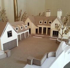 a paper model of a house with lots of windows and doors on top of it