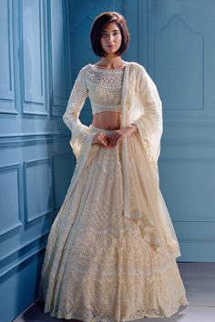 Ivory lehenga with attached cancan and hand embroidered off white sequins, bugle beads, and glass pipes. Comes with boat neck padded blouse and dupatta.
Component: 3
Embroidered
Neckline: Boat
Sleeve Length: Three Quarter
Fabric:  Net; Interlining: Satin
Color: White
Sheer sleeves
 - Aza Fashions Cream Floor-length Sets With Intricate Embroidery, Off White Embroidered Choli For Designer Wear, Designer Embroidered Off White Choli, Designer Embroidered Off-white Choli, Festive Cream Lehenga With Traditional Drape, Cream Sets With Resham Embroidery For Reception, Traditional Off White Gown For Designer Wear, Cream Bollywood Lehenga With Traditional Drape, Traditional Off-white Gown For Designer Wear