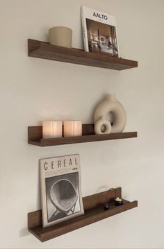 two wooden shelves with candles and pictures on them, one shelf has an ad for cereal