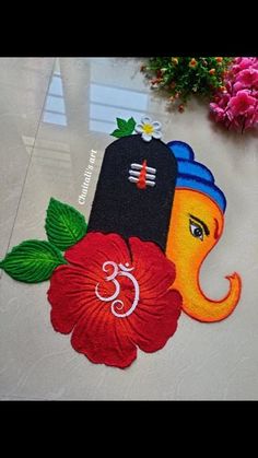 an elephant with a flower on the floor