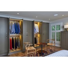 a bedroom with two closets and a bed next to it, all in grey