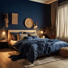 a bedroom with dark blue walls and wooden flooring is lit by two lamps on either side of the bed