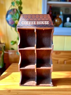 a wooden shelf that has some sort of coffee house on it