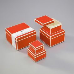 three orange boxes are stacked on top of each other and one has a white stripe