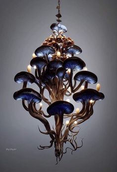 a chandelier with many blue flowers hanging from it's center and lights in the middle