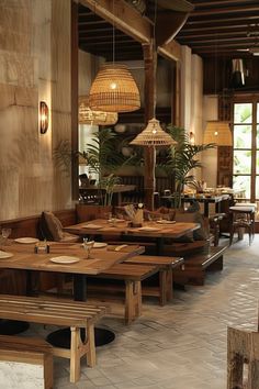 an empty restaurant with wooden tables and benches