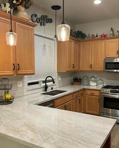 a kitchen with wooden cabinets and stainless steel appliances