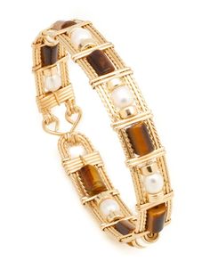 Beautiful wrapped wire bangle of 14k gold-filled wire with Tiger Eye Gemstone beads. Select from 4 different styles Approximately 1/2 inch wide. Tiger1 - Long Square Tube with Gold beads (BR_TigLSTGB_01) $119 Tiger2 - Long Square Tube w/Single Pearl & Gold beads (BR_TigLST1PGB_02) $129 Tiger3 - Long Square Tube with Pearls & Gold beads (BR_TigLSTPGB_03) $129 Tiger4 - Barrel with Pearls & Gold Beads (BR_TigBPGB_04) $129 Metal Wire Wrapped Beaded Bangle Bracelets, Wire Wrapped Metal Beaded Bangle Bracelet, Wire Wrapped Metal Beaded Bangle, Wire Wrapped Beaded Bangle Bracelets, Metal Bangle Jewelry With Wire Wrapped, Gold Wire Wrapped Beaded Bracelet, Adjustable Wire Wrapped Gold Bangle, Adjustable Gold Wire Wrapped Bangle, Gold Wire Wrapped Metal Bracelets