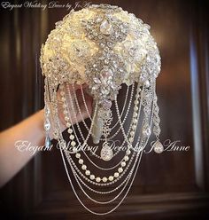 the bridal bouquet is adorned with pearls and crystal beads, which are attached to chains