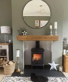 a living room with a wood stove and mirror