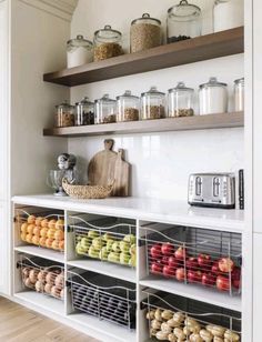 a kitchen with open shelving and lots of food