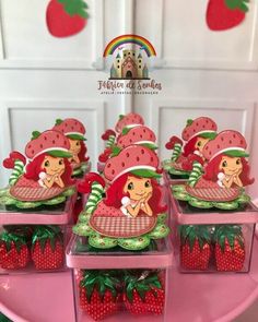 strawberry shortcakes are arranged on pink trays