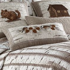 the comforter is made up with brown and white bedding, including a cat