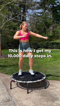 a woman standing on top of a trampoline with her arms spread out and the words, this is how i get my 10, 000 daily steps in