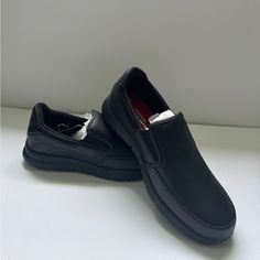 Size: 10 Never Been Used Black Low-top Slip-ons For Walking, Black Slip-ons With Round Toe For Walking, Black Moc Toe Slip-ons With Cushioned Footbed, Black Casual Walking Shoes For Business, Black Casual Business Walking Shoes, Black Ortholite Low-top Slip-ons, Black Slip-resistant Synthetic Slip-ons, Black Slip-resistant Slip-ons For Business, Black Plain Toe Walking Shoes For Formal Occasions