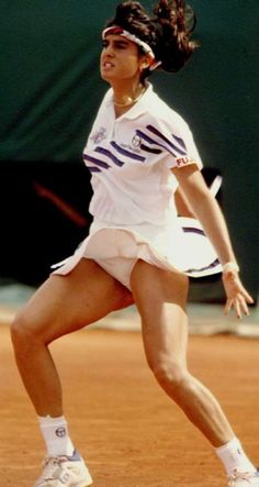 a female tennis player in action on the court