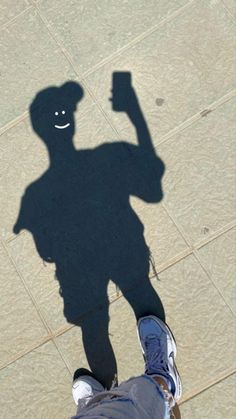 a shadow of a person holding a cell phone