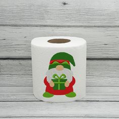 a roll of toilet paper with an image of a santa clause holding a gift box