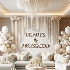 a living room filled with white couches and balloons